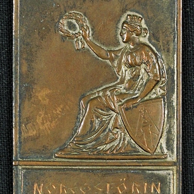 Merki. Á framhlið merkisins stendur: NOREGSFÖRIN 1938.